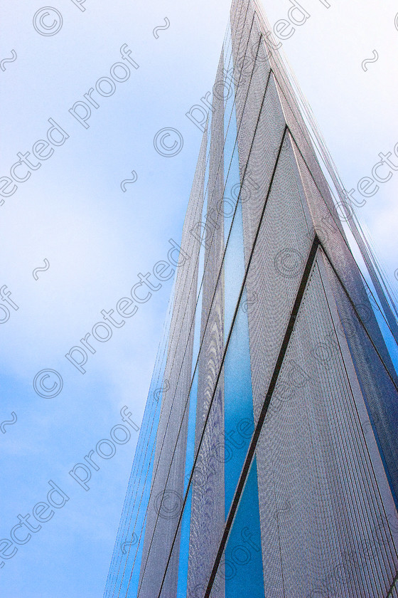 Modern building arty 
 This image has been manipulated to give a softer feel, with a fine grain in the highlights & more of a punch to the blue. 
 Keywords: Building, modern, structure, arty, metal, sky, sharp, steel, glass