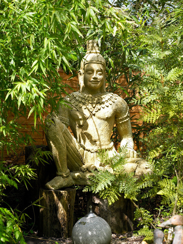 West Malling-23 
 The Buddha spotted outside a local antique shop & place in position by the shop owner. 
 Keywords: garden Kent flowers flower beds pots scuplture town garden statues Buddha